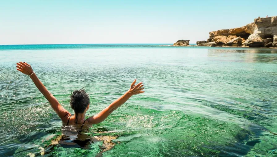 Woman swimming in clear sea water