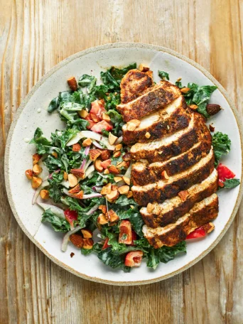 Blackened chicken with a kale, strawberry, and almond salad