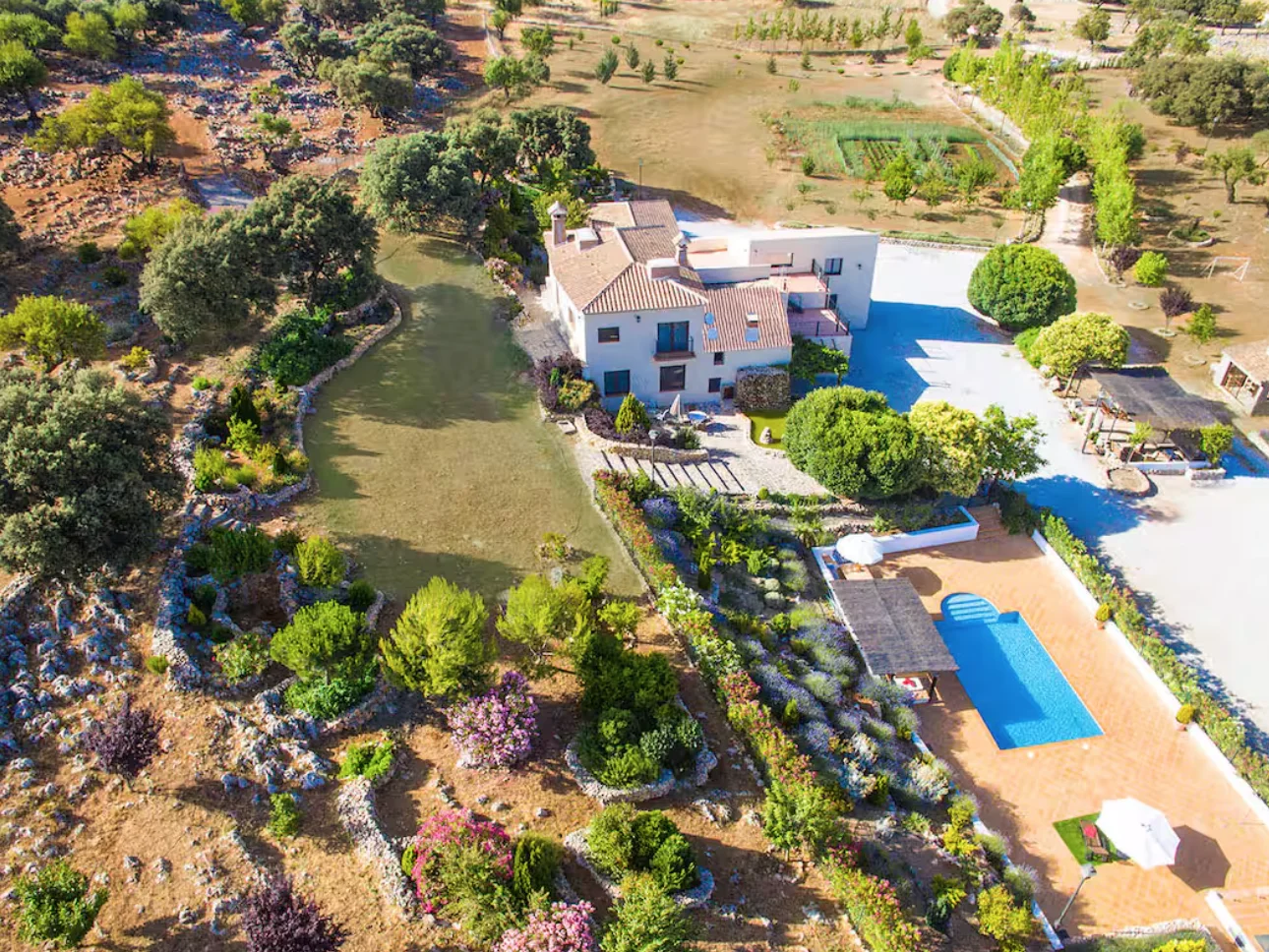 Aerial view of the villa, gardens, and pool